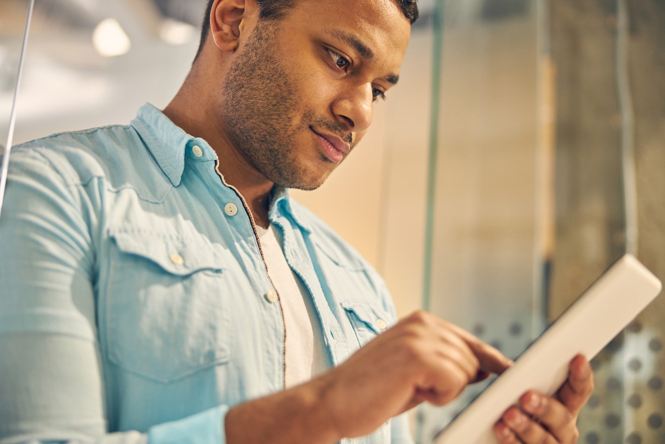 Kind young male person reading news online